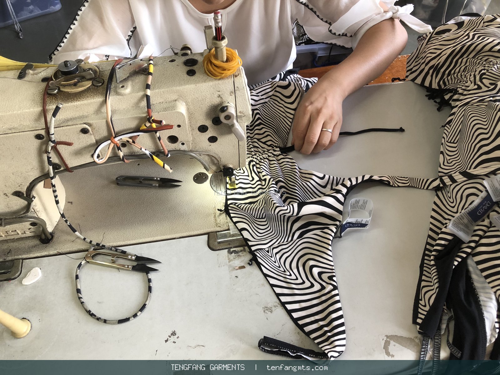 Operator carefully sewing a patterned garment